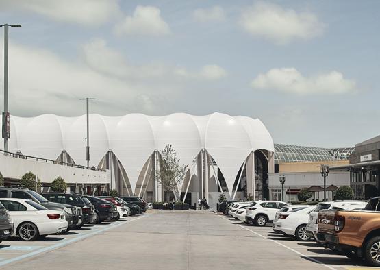 a parking lot with a large white building