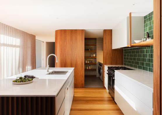 a kitchen with white cabinets and a sink