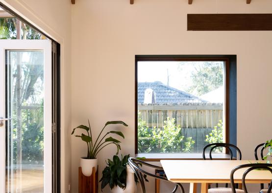 a dining table and chairs in a room with a glass door