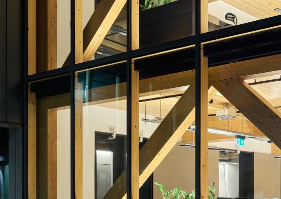 a glass window with wood beams and a wooden ceiling