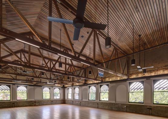 a room with a ceiling fan and windows