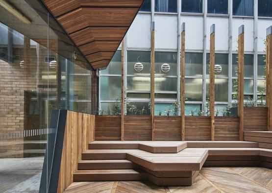 a wooden floor with stairs and a glass wall