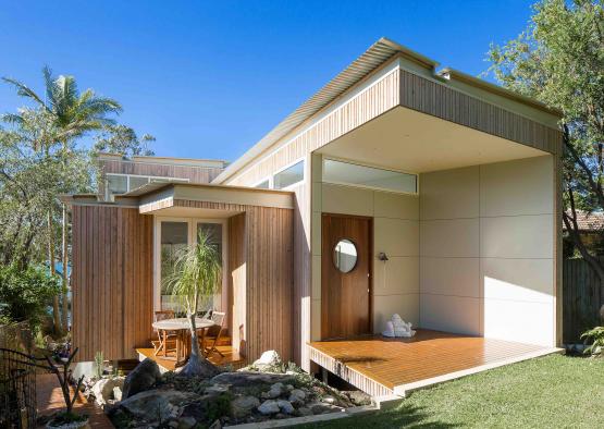 a house with a wood wall and a wood deck