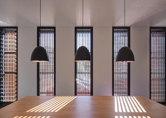 a table with black lamps from ceiling