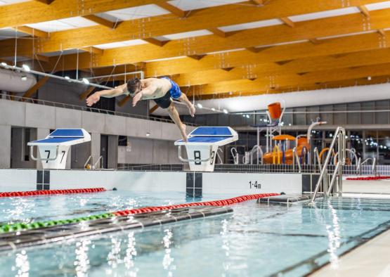 a man jumping into a pool