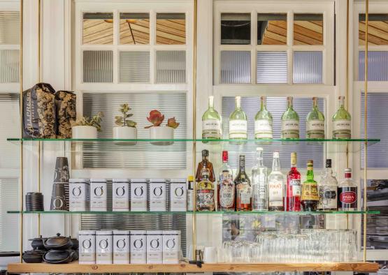 a shelf with bottles and glasses