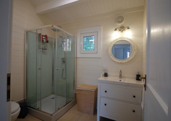 a bathroom with a glass shower and sink