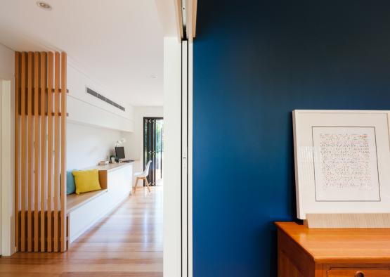 a room with a blue wall and a wood table