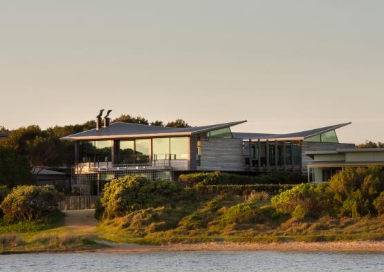 a building with a glass roof and a body of water