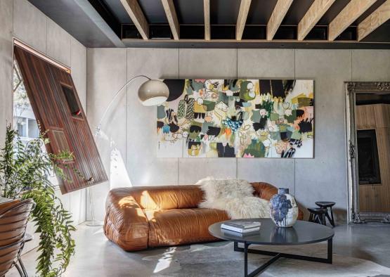 a living room with a couch and a painting on the wall