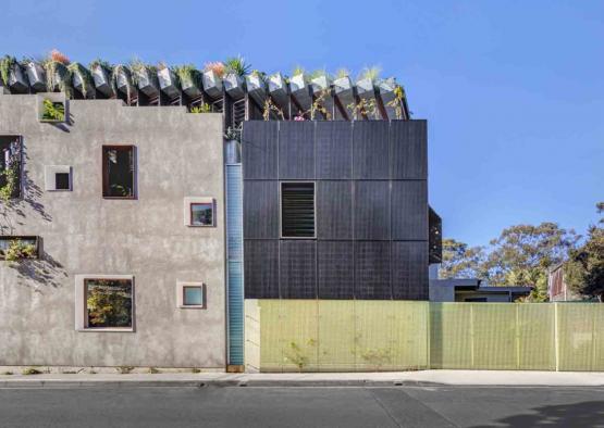 a building with plants on the roof