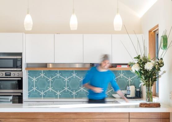 a man in a blue shirt in a kitchen