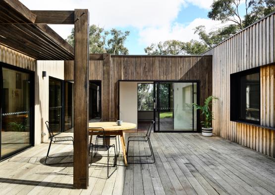 a patio with a table and chairs