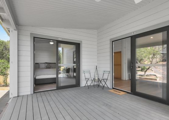 a patio with a bed and chairs