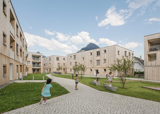 a group of kids playing in a courtyard of a building