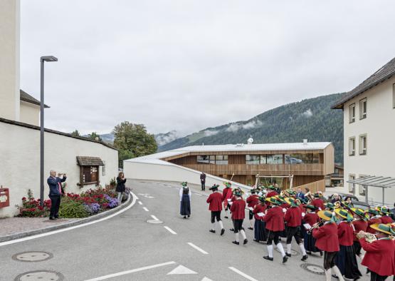 a group of people in red uniforms walking down a street