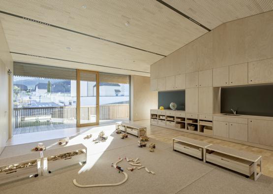 a room with wooden walls and a large window