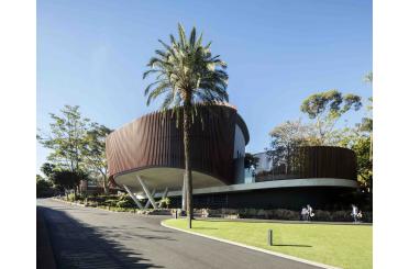 a building with a curved roof and palm trees