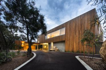 a house with a driveway and trees