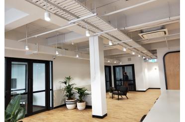 a room with white pillars and plants