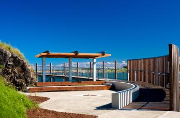 a walkway with a wooden structure and a fence