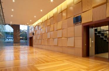 a room with a wooden floor and a large doorway