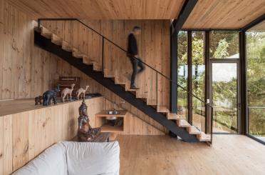 a man walking up a staircase in a house